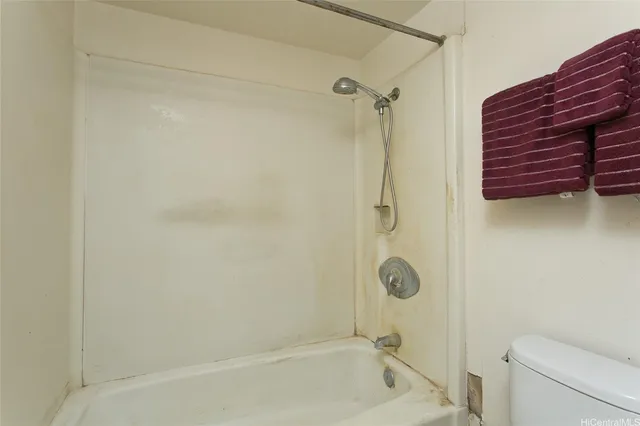 a bathroom with a shower a toilet and sink