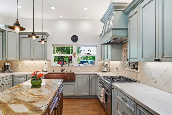 a kitchen with stainless steel appliances granite countertop a stove and a refrigerator