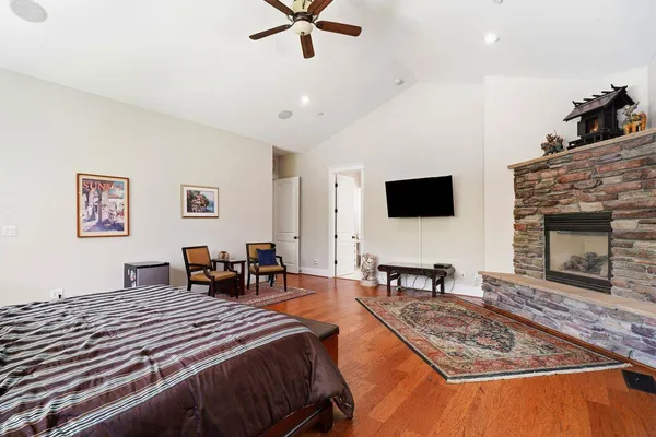a living room with stainless steel appliances furniture a flat screen tv and a window