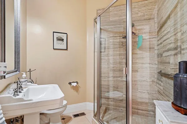 a bathroom with a sink a vanity a mirror and shower