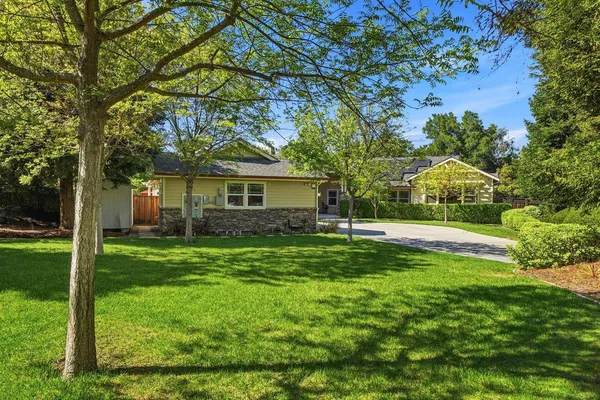 a view of a house with a backyard