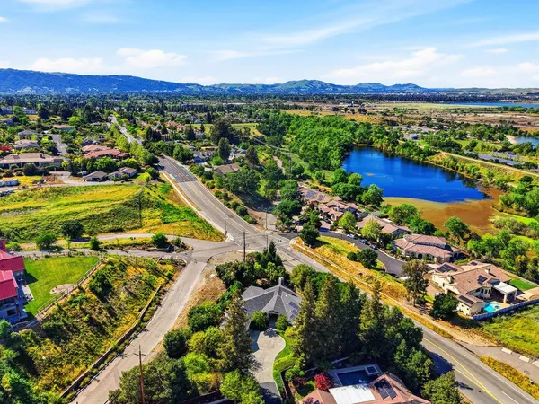 an aerial view of residential houses with outdoor space and swimming pool