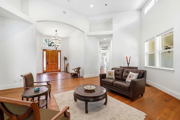 a living room with furniture and a chandelier