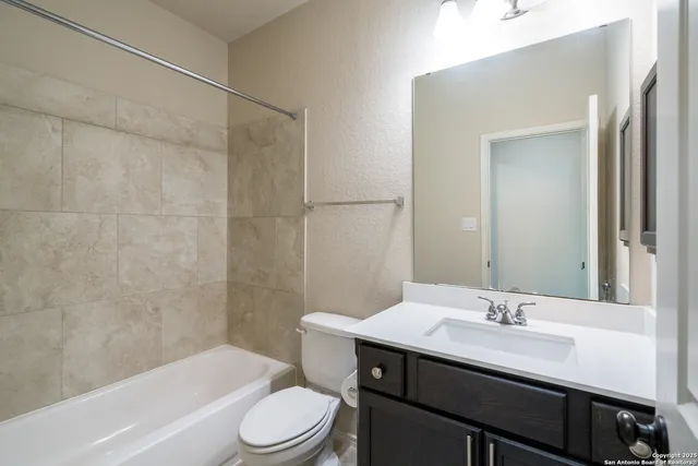 a view of a hallway with wooden floor and cabinet