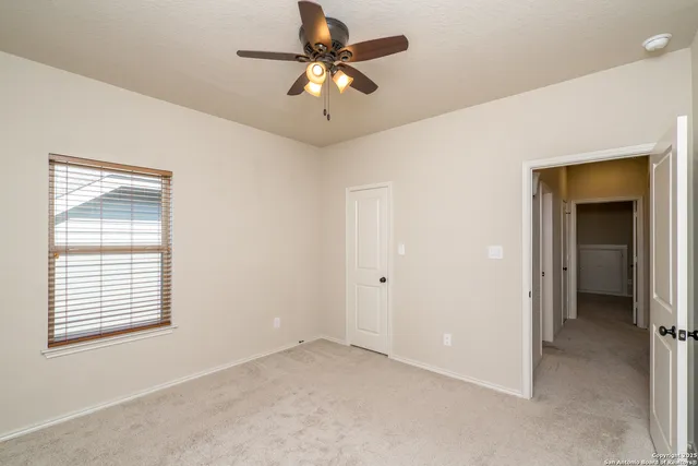 a large kitchen with stainless steel appliances wooden cabinets a stove and a sink