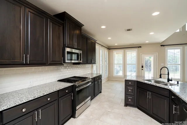 an empty room with closet and a chandelier fan