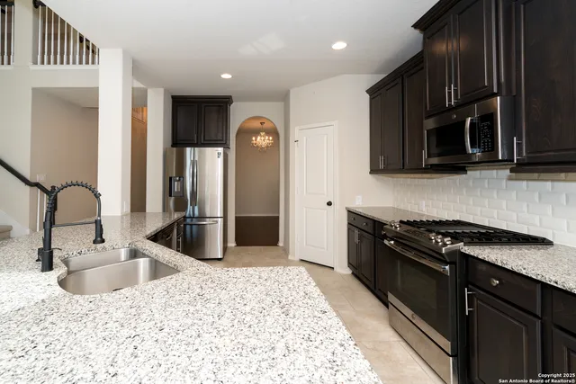 a spacious bathroom with a double vanity sink a mirror and a shower