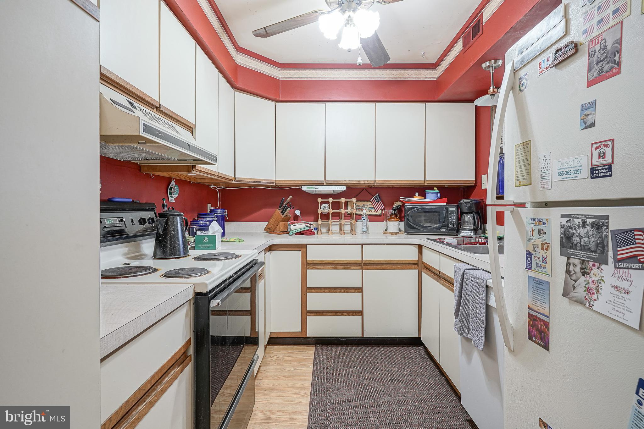 40 Tansboro Road, Unit 7B Berlin, NJ 08009 - Photo 9 of 20 a kitchen with stainless steel appliances a sink cabinets and wooden floor