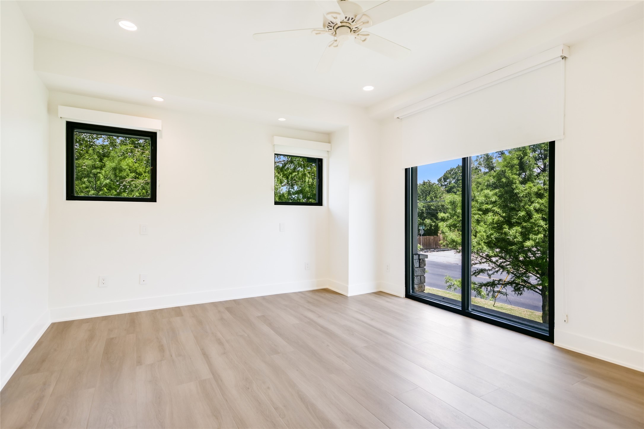 1603 Enfield Road, Unit 200 Austin, TX 78703 - Photo 15 of 27 an empty room with wooden floor and windows