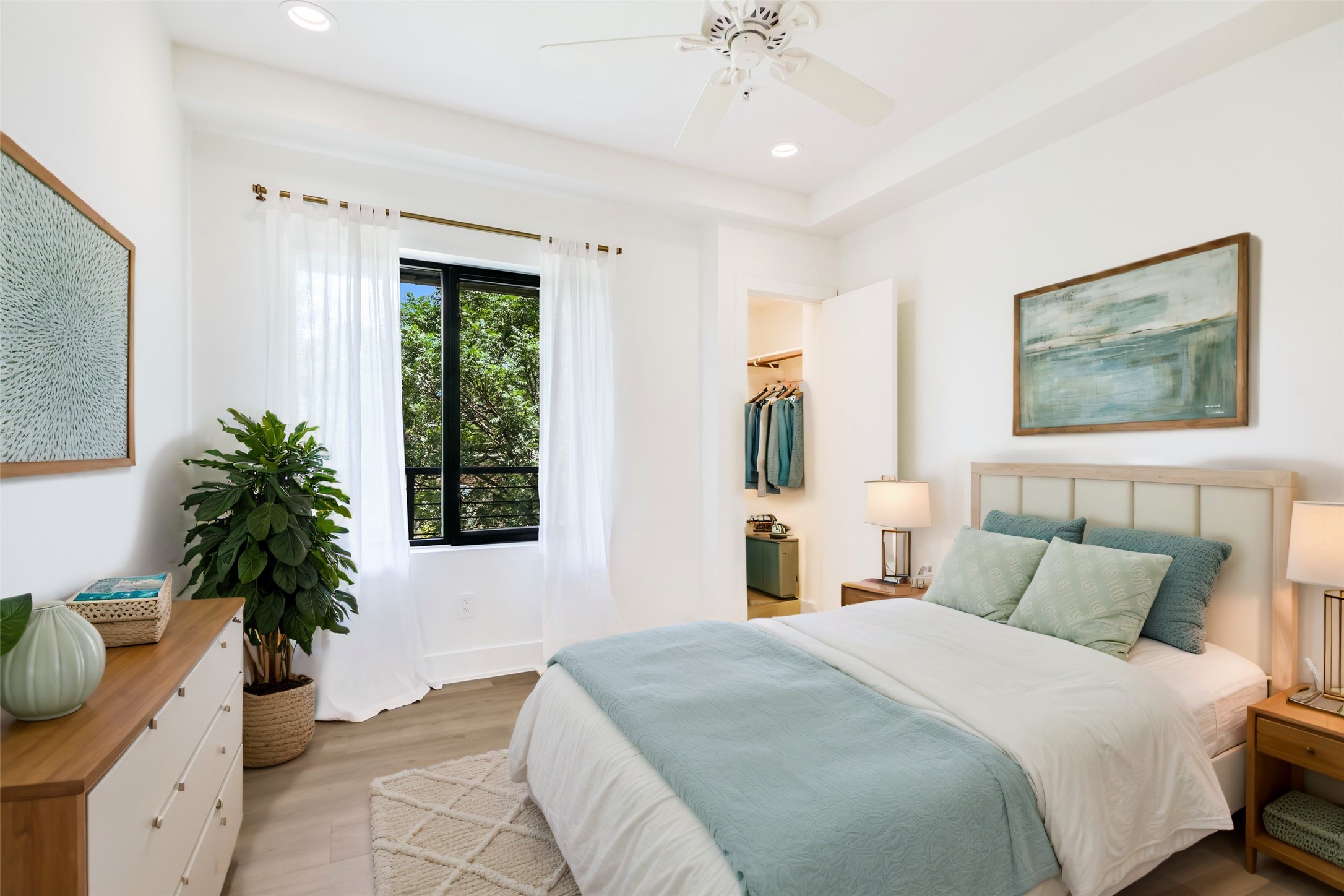 1603 Enfield Road, Unit 200 Austin, TX 78703 - Photo 19 of 27 a bedroom with a large bed and a potted plant