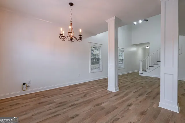 a view of a hallway with wooden floor