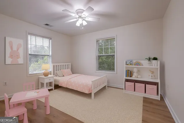 a view of a house with a yard and wooden fence