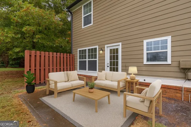 a view of a house with swimming pool and sitting area