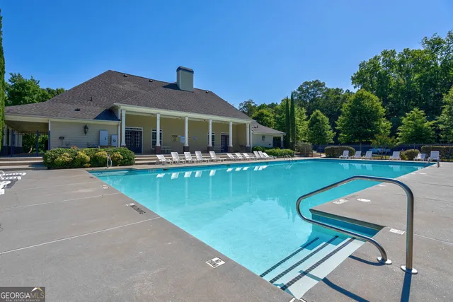 a view of a patio with swimming pool and furniture
