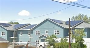 215 Northwest 11th Street Hermiston, OR 97838 - Photo 7 of 8 a front view of a house with a yard and potted plants