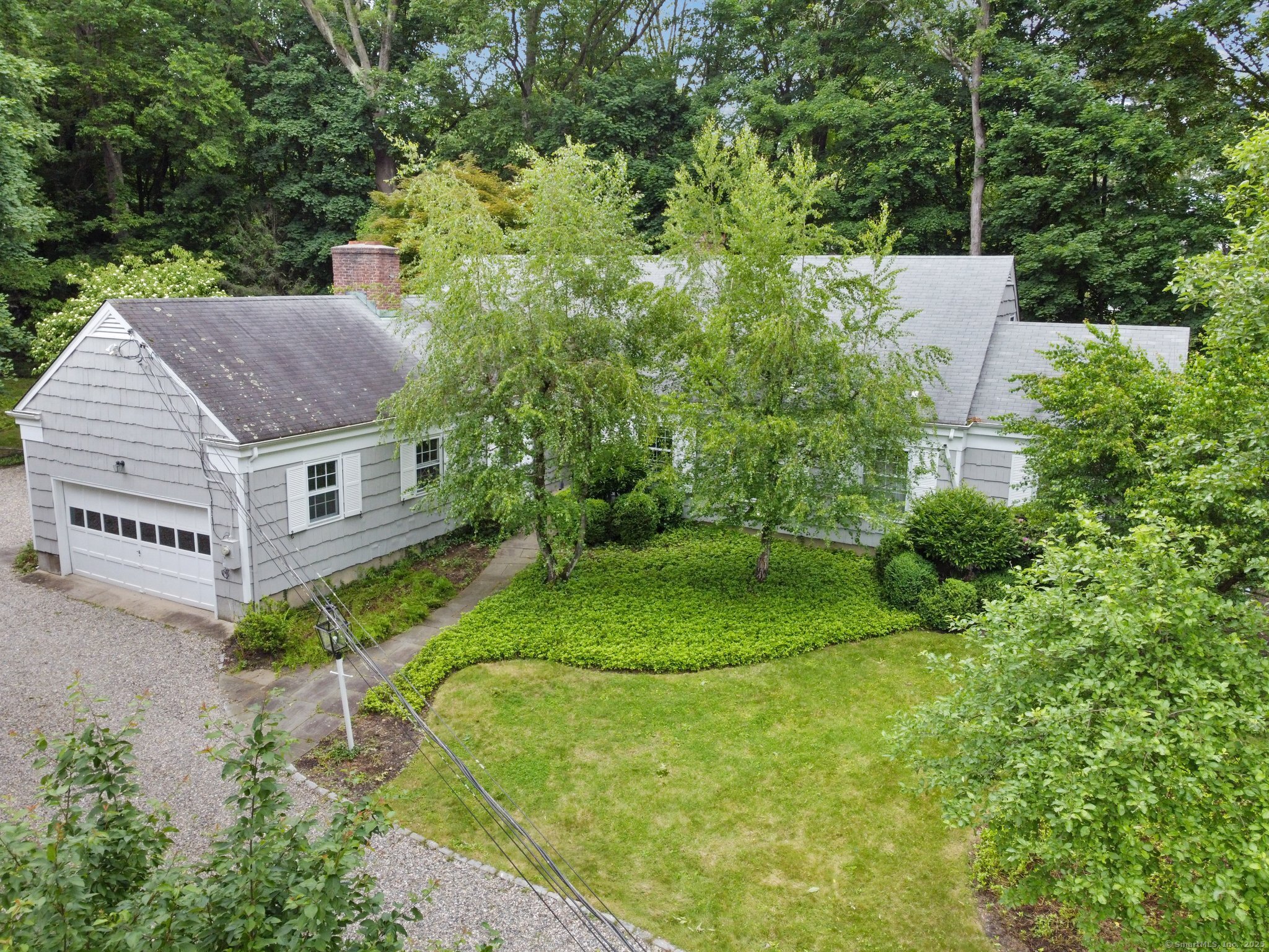 345 Hollow Tree Ridge Road Darien, CT 06820 - Photo 1 of 1 a aerial view of a house with a yard and sitting area