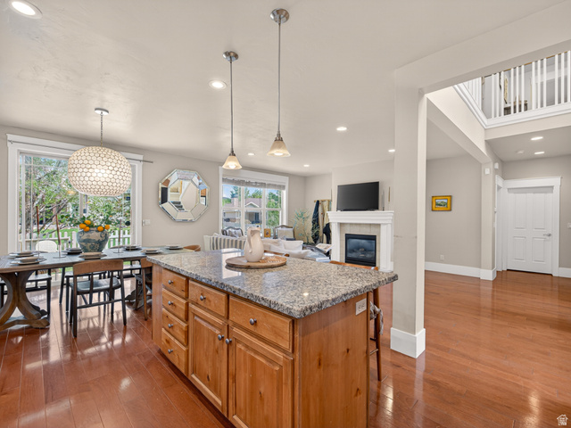 557 Craftsman Way Midway, UT 84049 - Photo 22 of 59 Kitchen island with stone countertop and wood cabinetry