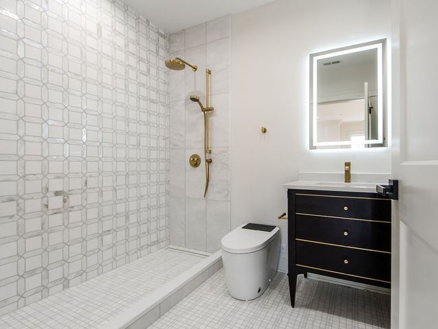 a spacious bedroom with a bed a couch and a window