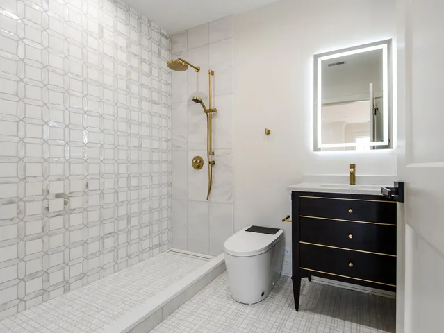 a spacious bedroom with a bed a couch and a window