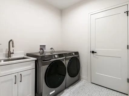 a kitchen with stainless steel appliances kitchen island granite countertop a sink stove and cabinets