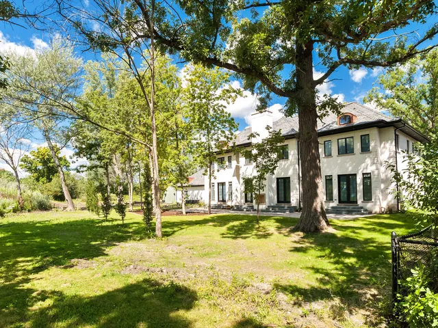 a backyard of a house with large trees