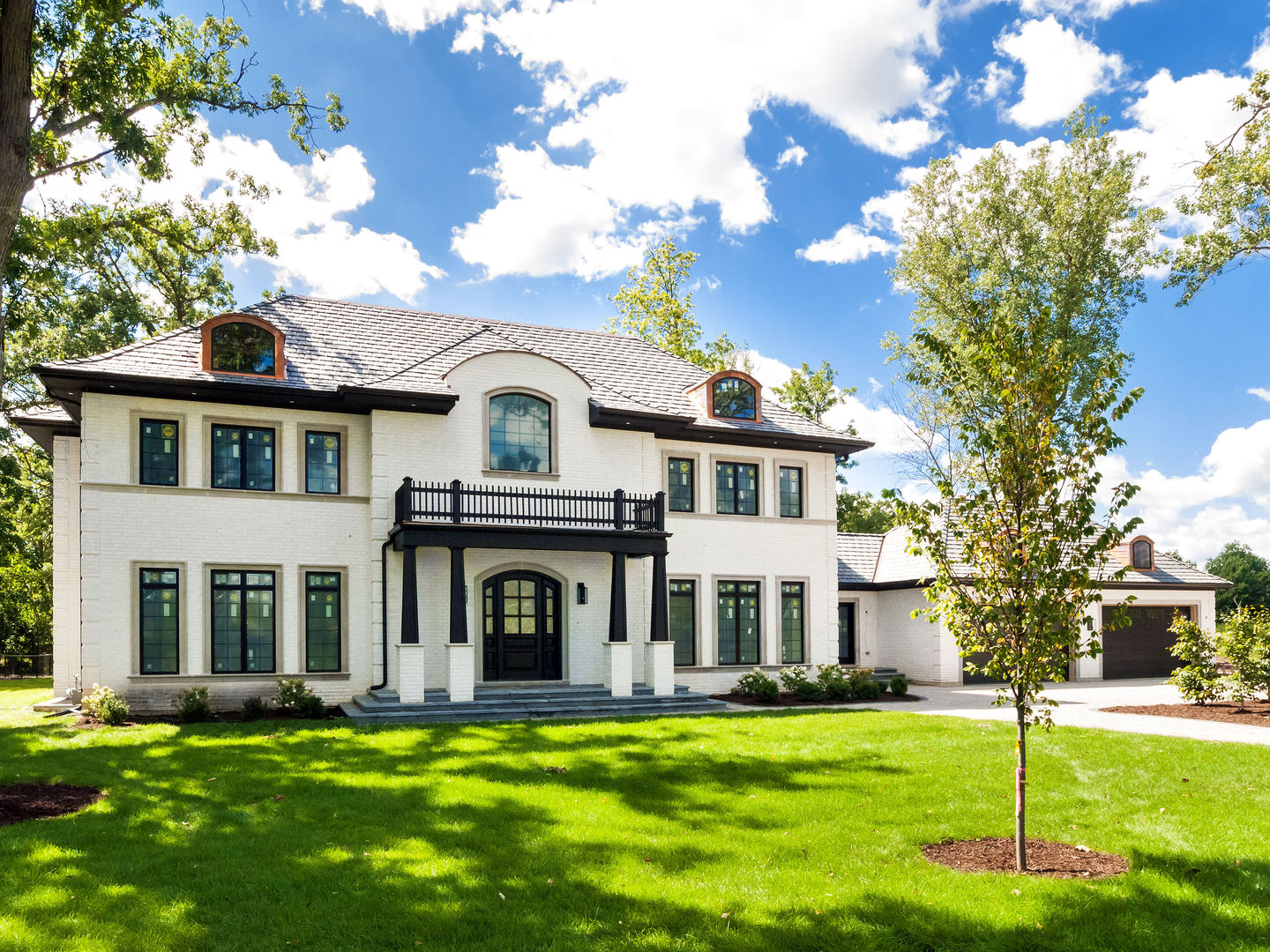 1 Morrison Road Northbrook, IL 60062 - Photo 47 of 58 a view of a white house with a big yard and potted plants