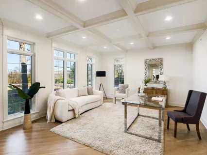 a spacious bedroom with a bed a couch and large windows