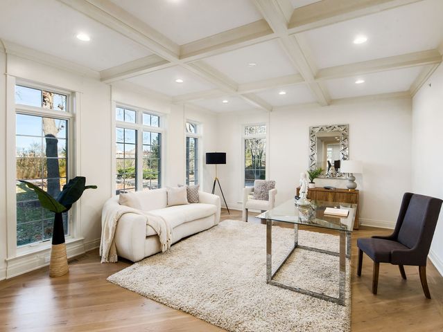 a spacious bedroom with a bed a couch and large windows