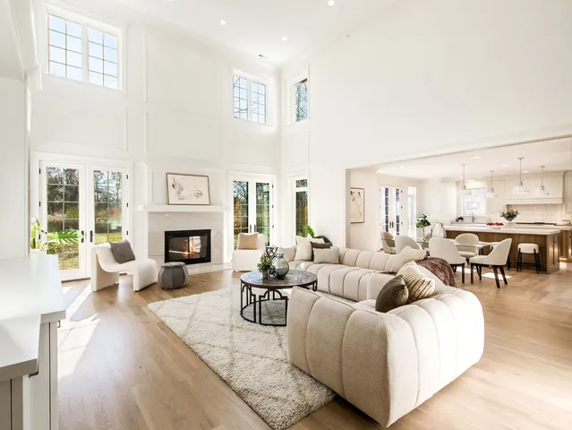 a living room with furniture or couches and a dining table with wooden floor