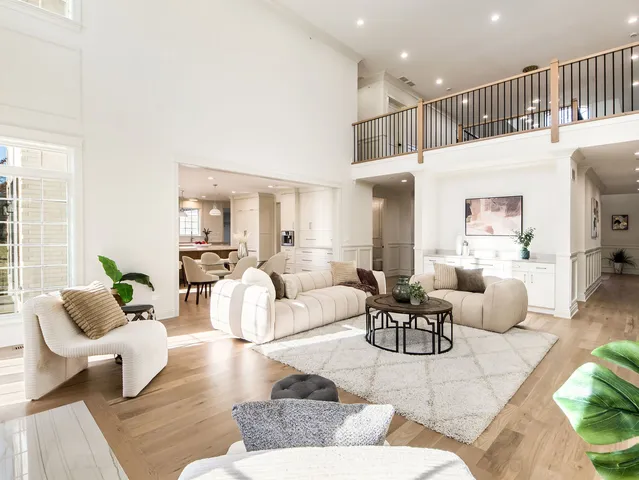 a living room with furniture large window and a fireplace