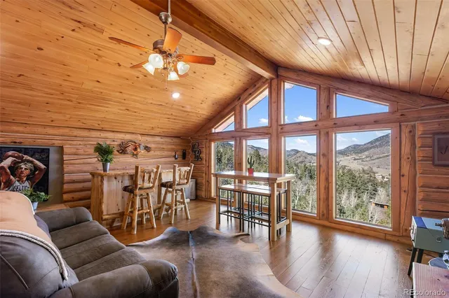 a dining room with furniture windows and wooden floor