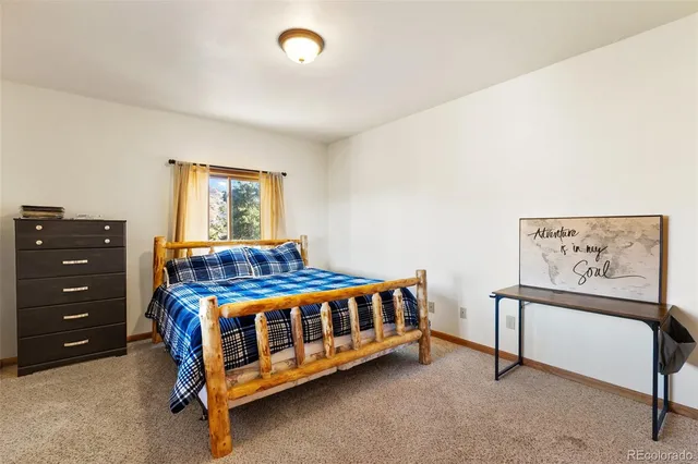 a bedroom with a bed next to a window