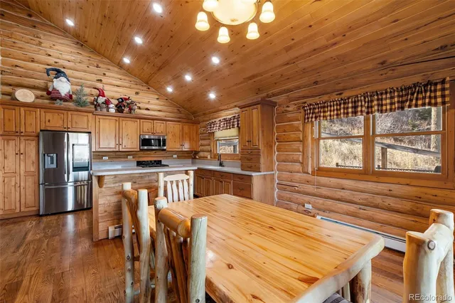 a kitchen with a table and chairs in it