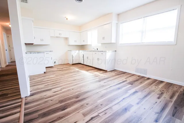 a view of kitchen and wooden floor