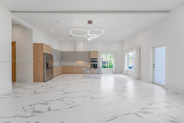 a view of a kitchen with a sink and a refrigerator