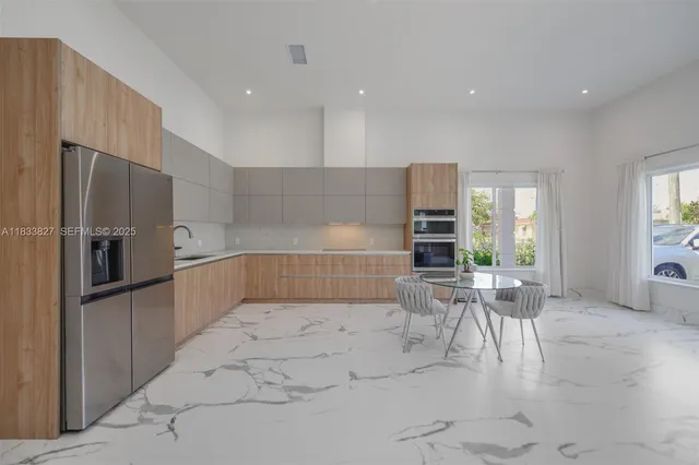 a kitchen with stainless steel appliances kitchen island granite countertop a sink and cabinets