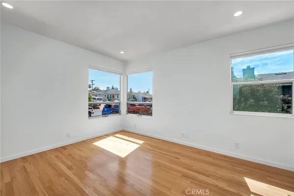 a view of a room with wooden floor and a window