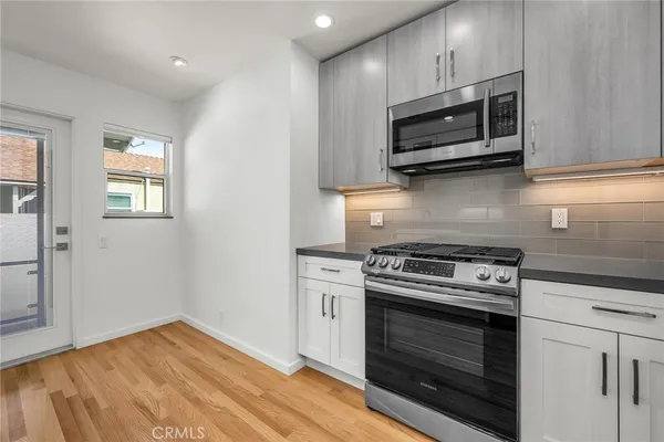 a kitchen with a stove and a microwave