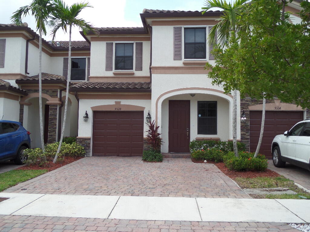 9328 West 33rd Way Hialeah, FL 33018 - Photo 1 of 24 a front view of a house with garden