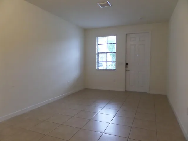 an empty room with sliding door and windows