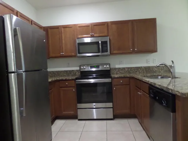 a view of kitchen with refrigerator and microwave