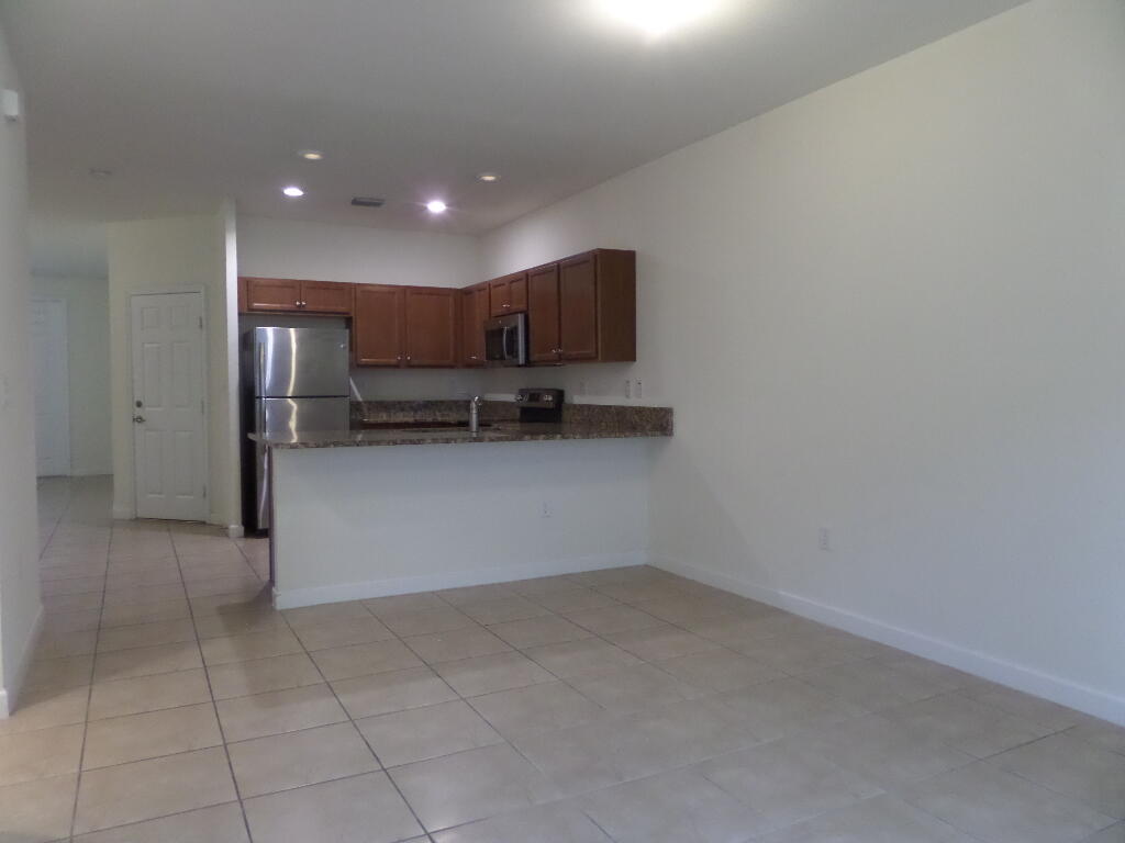 9328 West 33rd Way Hialeah, FL 33018 - Photo 7 of 24 a view of kitchen with refrigerator and microwave