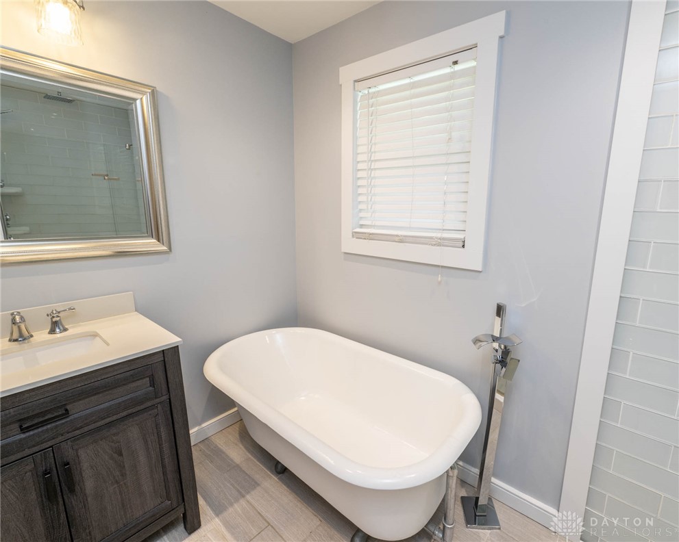190 Swailes Road Troy, OH 45373 - Photo 32 of 82 This serene bathroom offers a classic freestanding tub and modern vanity, creating a refreshing retreat.