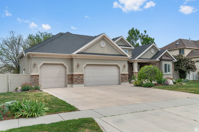 439 East 13540 South Draper, UT 84020 - Photo 46 of 46 Stucco exterior with stone accents, a two-car garage, and a concrete driveway