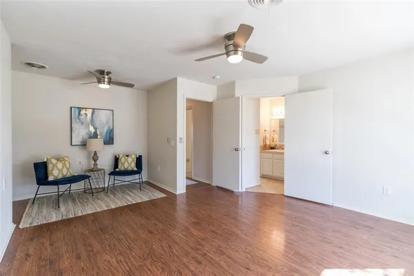 a bathroom with a granite countertop toilet a sink and a mirror