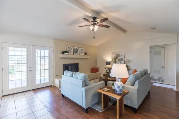 a living room with furniture and a view of kitchen