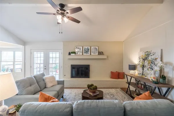 a living room with furniture and a chandelier