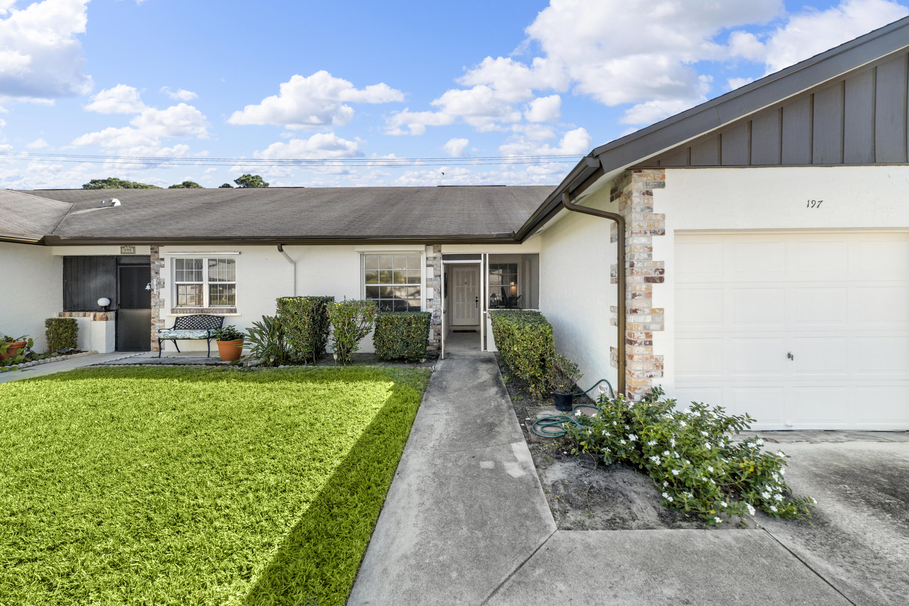 a front view of a house with garden