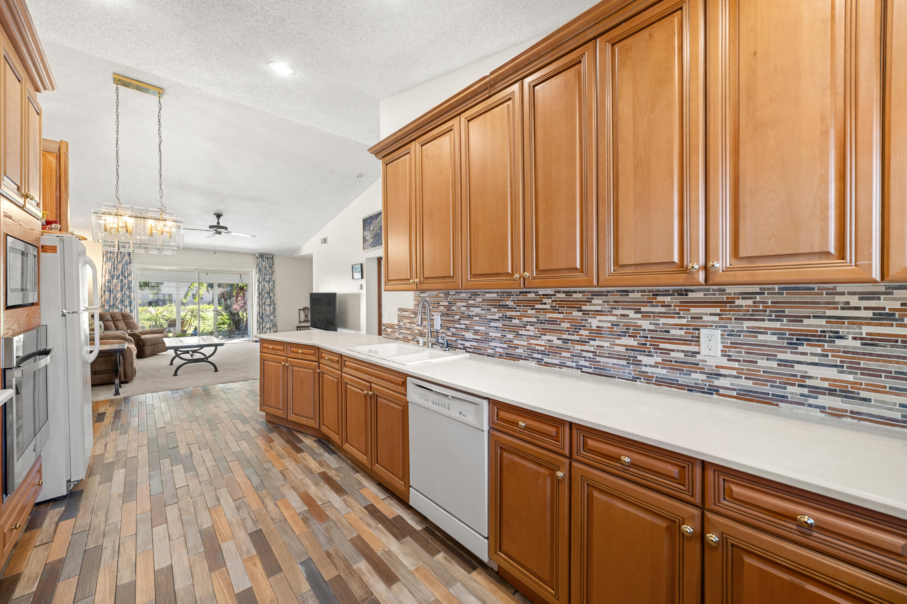 197 Bent Arrow Drive Jupiter, FL 33458 - Photo 11 of 33 a large kitchen with kitchen island wooden floors and wooden cabinets