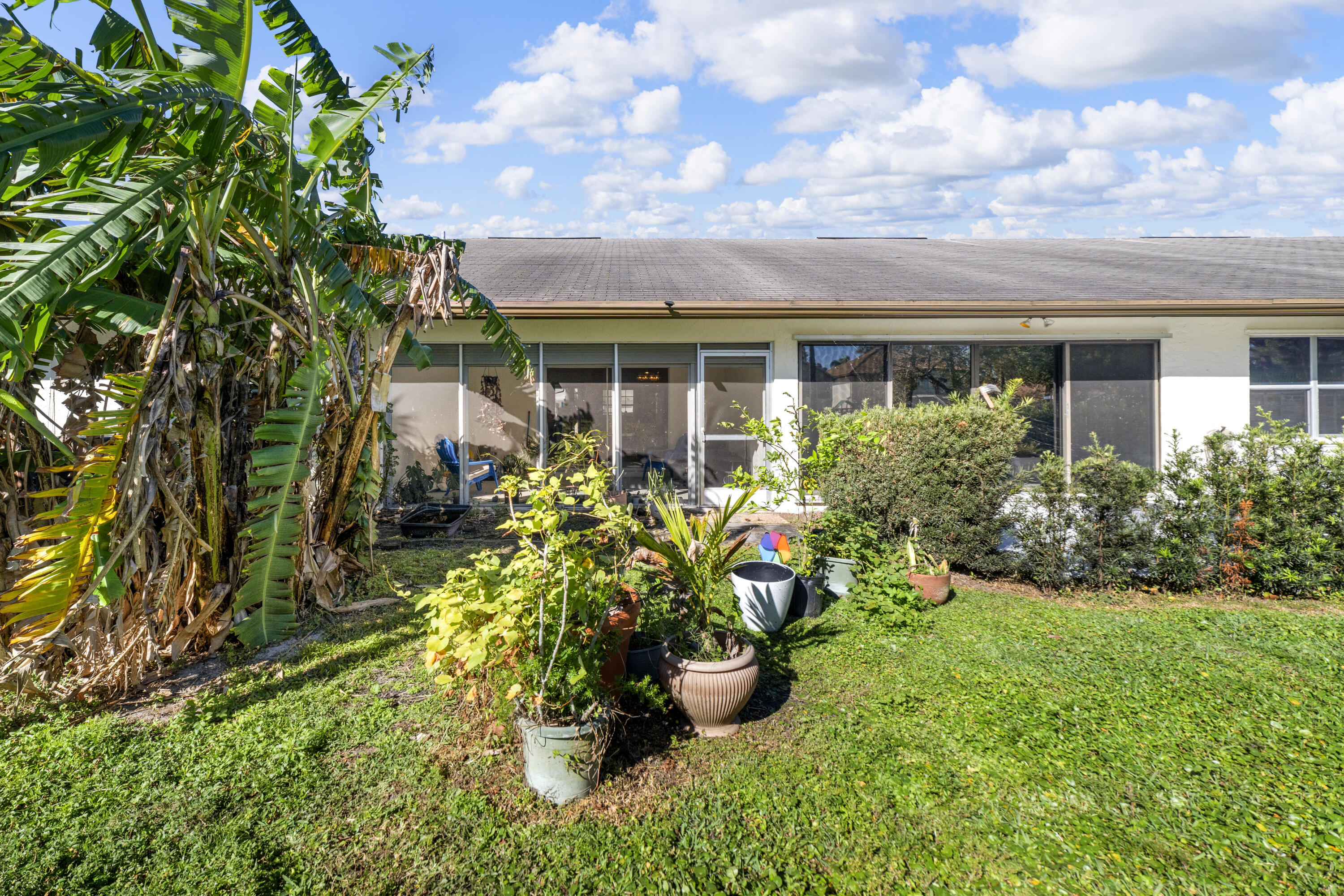 197 Bent Arrow Drive Jupiter, FL 33458 - Photo 20 of 33 a view of a garden with a fountain